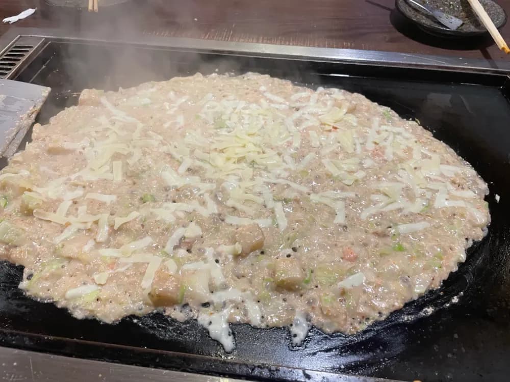 Monjayaki atop a hot plate in Moheji in Tsukishima, Tokyo