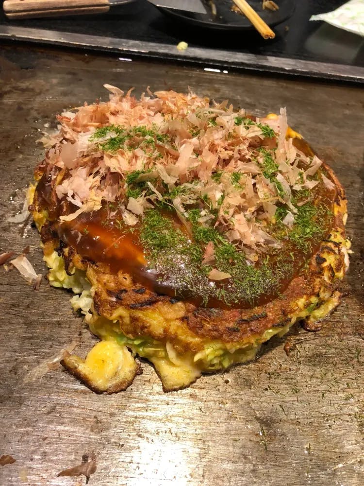 Okonomiyaki served on a hot plate
