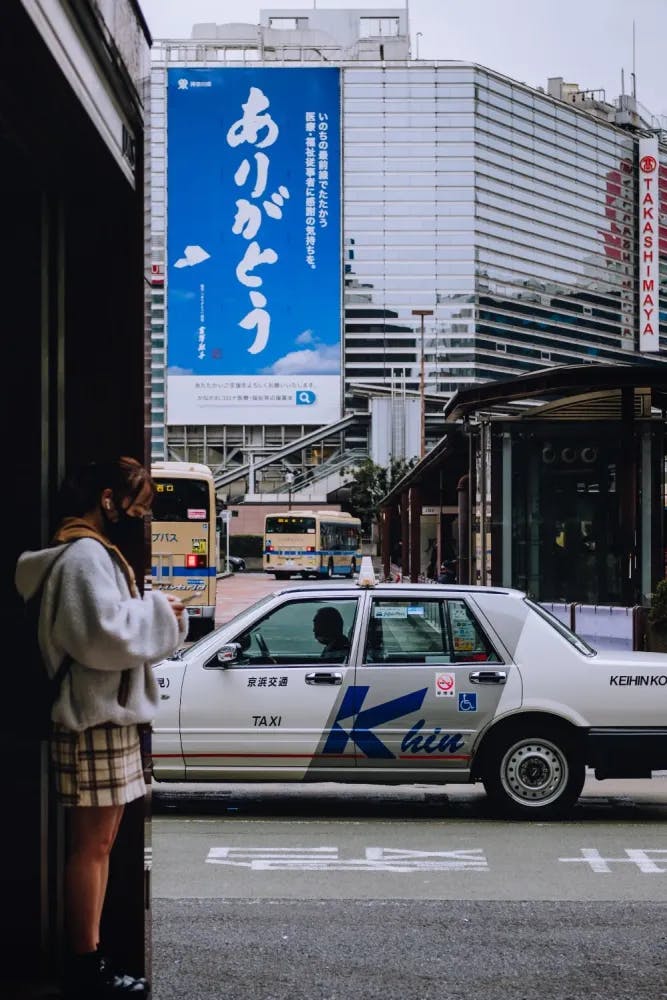 Taxi passing by outside Yokohama Station in Yokohama, Kanagawa Prefecture