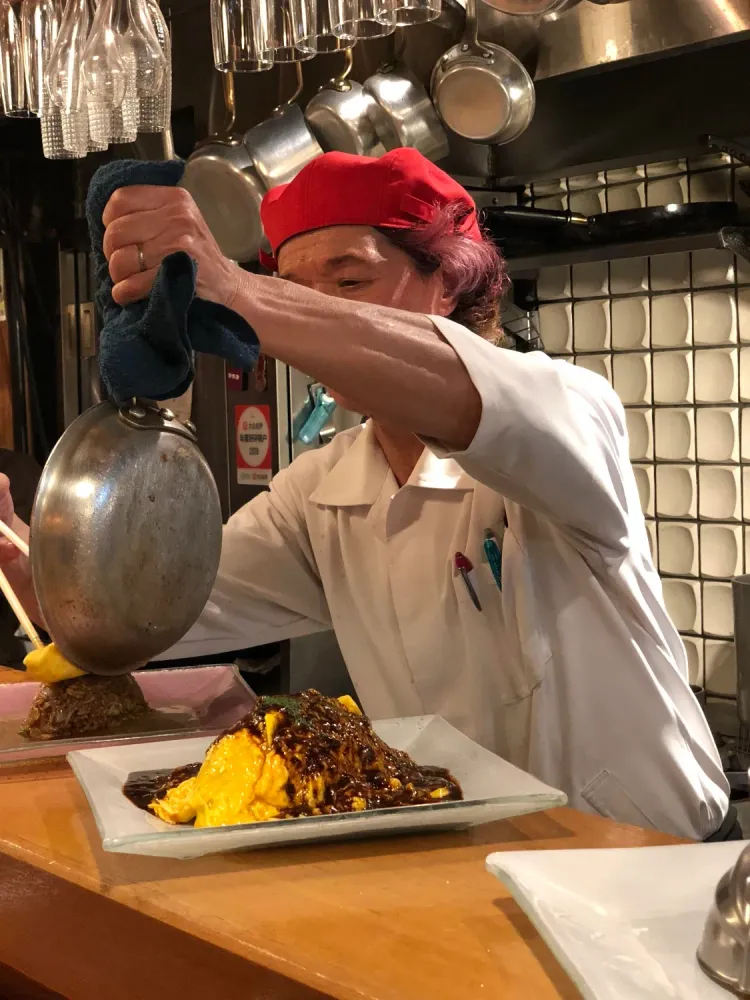 Chef serving up omurice at Kichi Kichi in Kyoto, Kyoto Prefecture