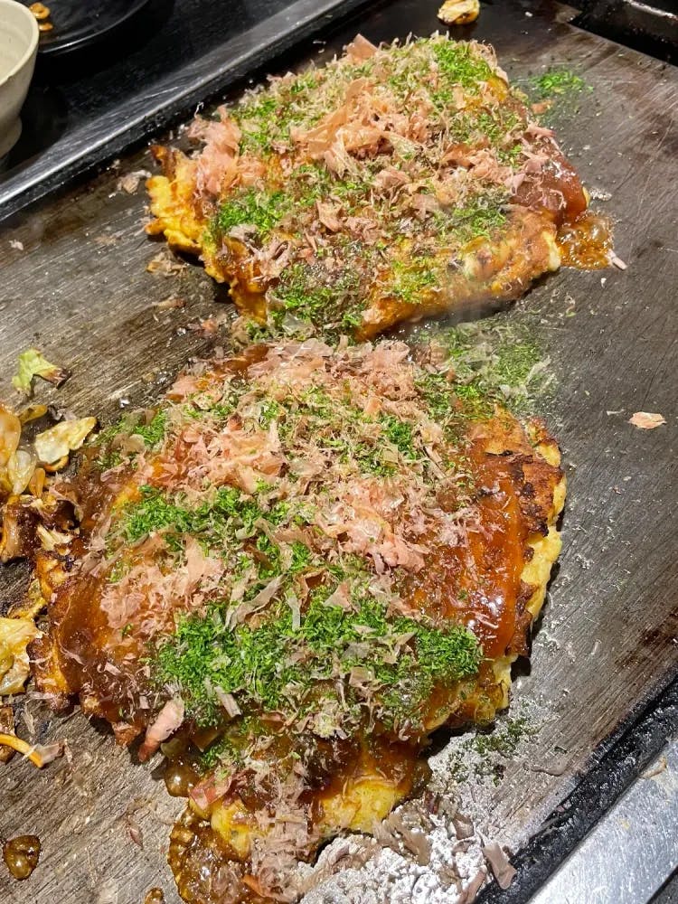 Okonomiyaki served on a hotplate at Ajinoya in Osaka, Osaka Prefecture