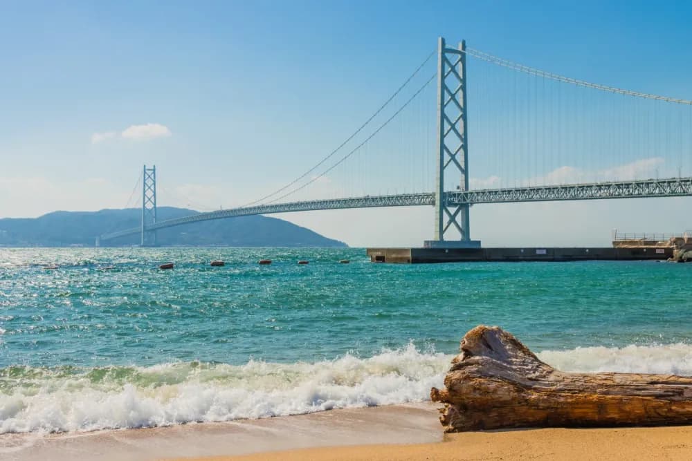 Panoramic shot of the Akashi Kaikyo Bridge from a beach in Kobe, Hyogo Prefecture