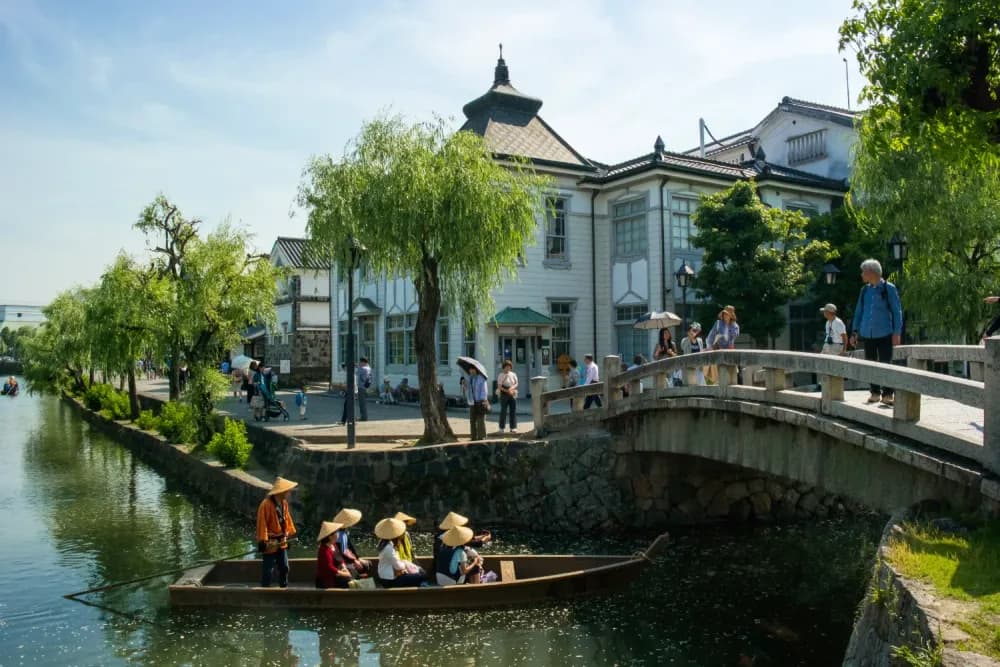 People sitting on a canal boat in Kurashiki, Okayama Prefecture